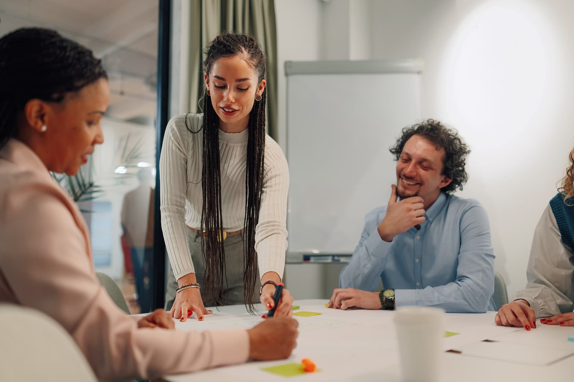 A team working around a table covered in notes